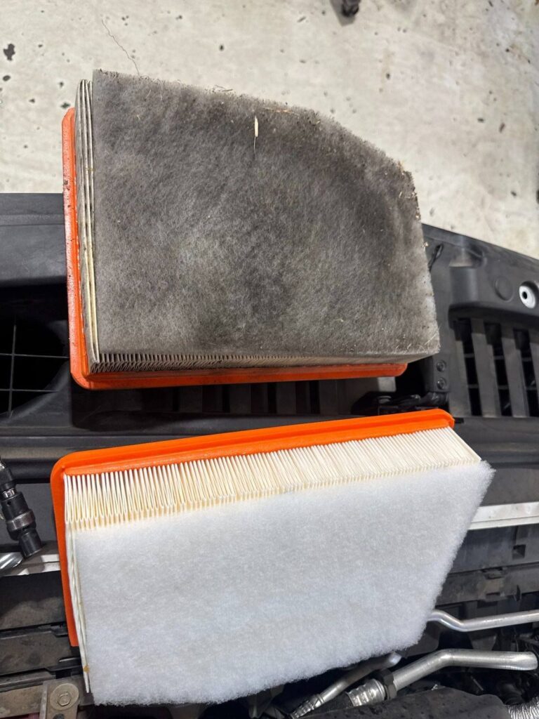 Picture of a air filter being serviced on a vehicle.