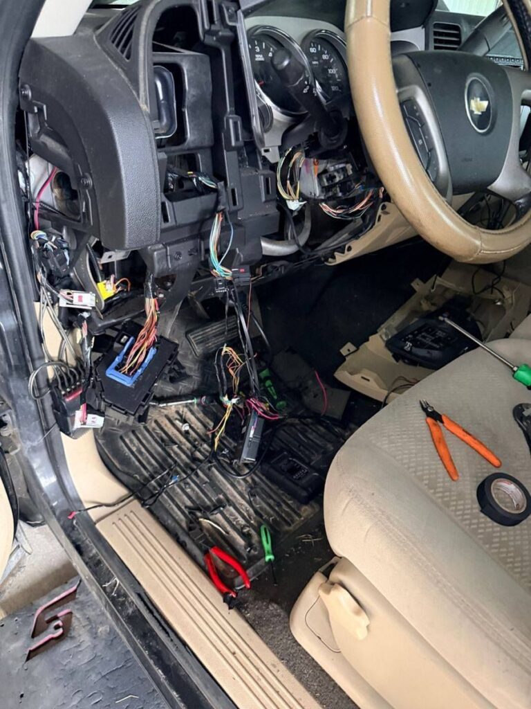 Picture of an automotive electrical system being inspected for an issue.